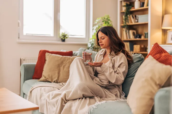 woman with winter fatigue sitting on the couch.