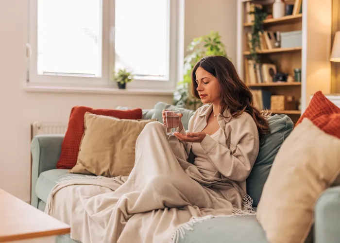 woman with winter fatigue sitting on the couch.