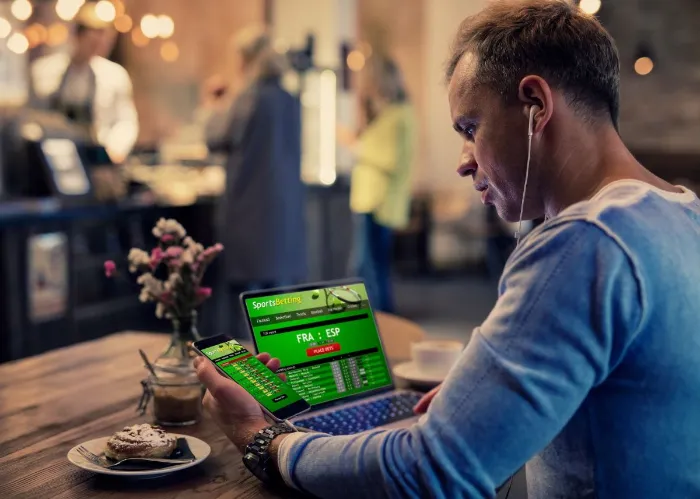 man struggling with sports gambling