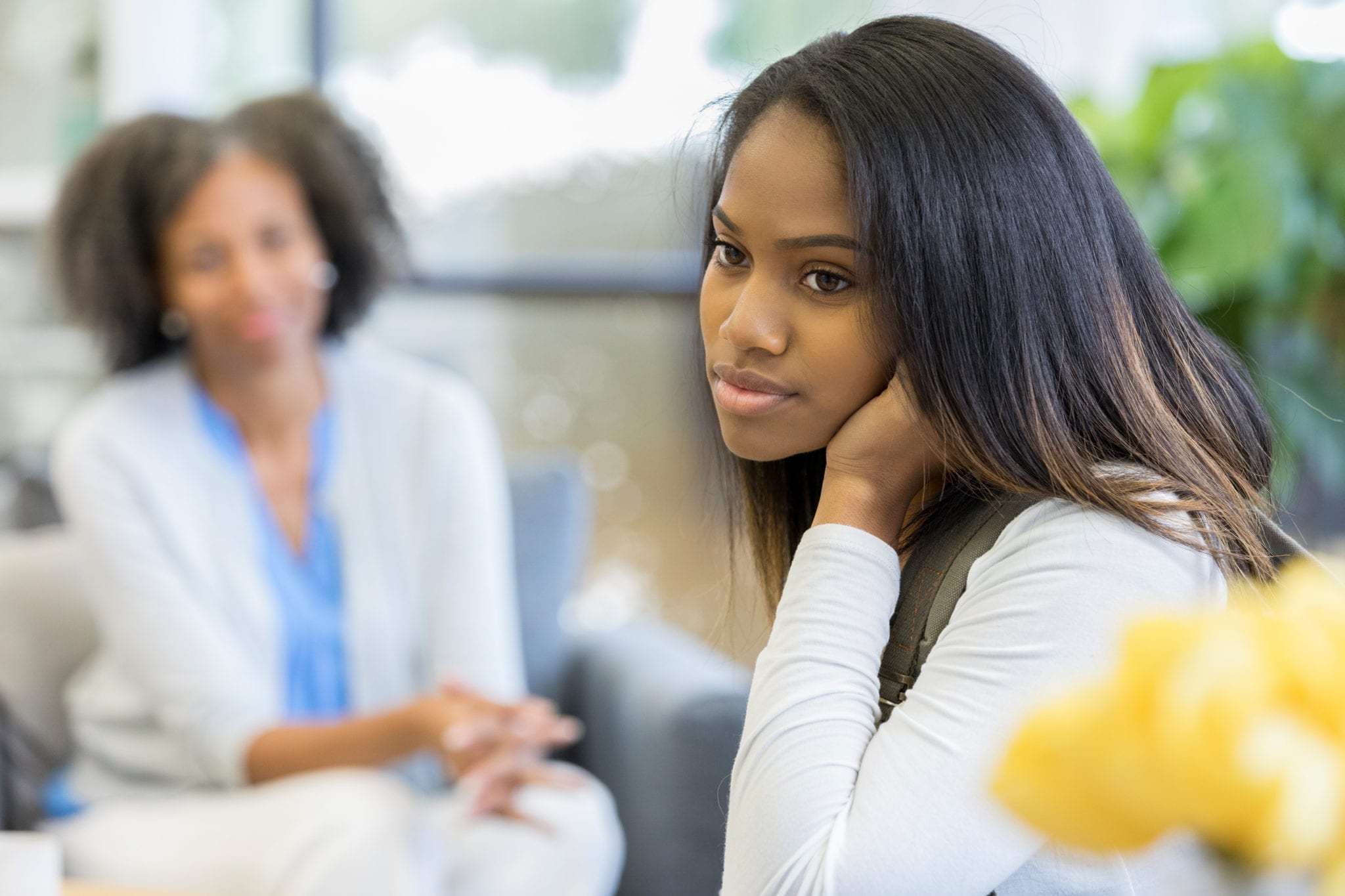 Image of a woman speaking with a teenage girl.