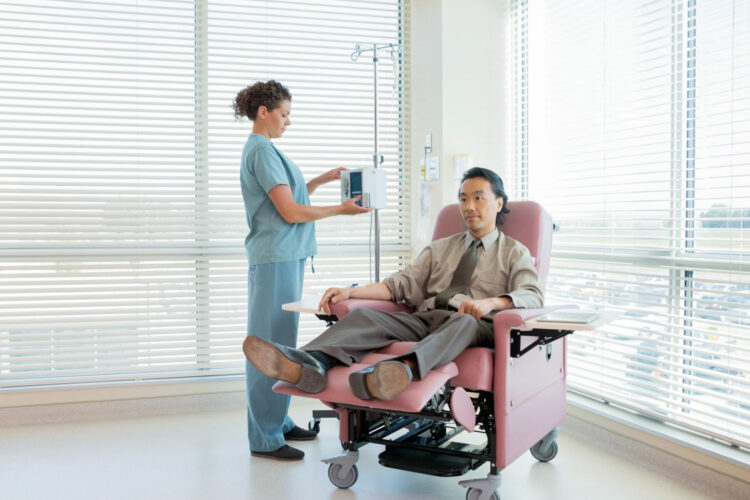 Nurse Operating IV Machine For Patient